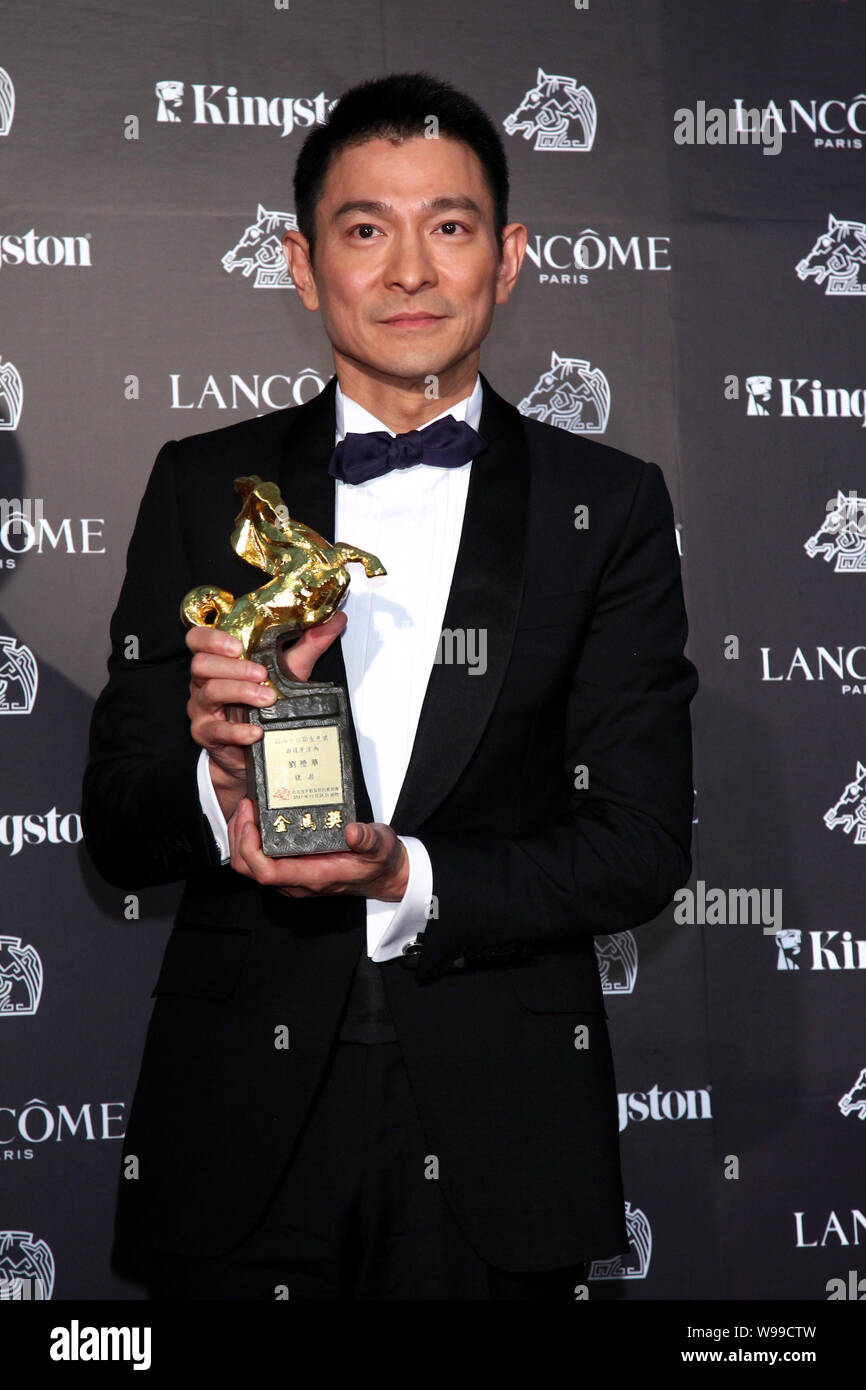 Andy Yu Hong Kong singer and actor Andy Lau holds his trophy for the Best Actor ...