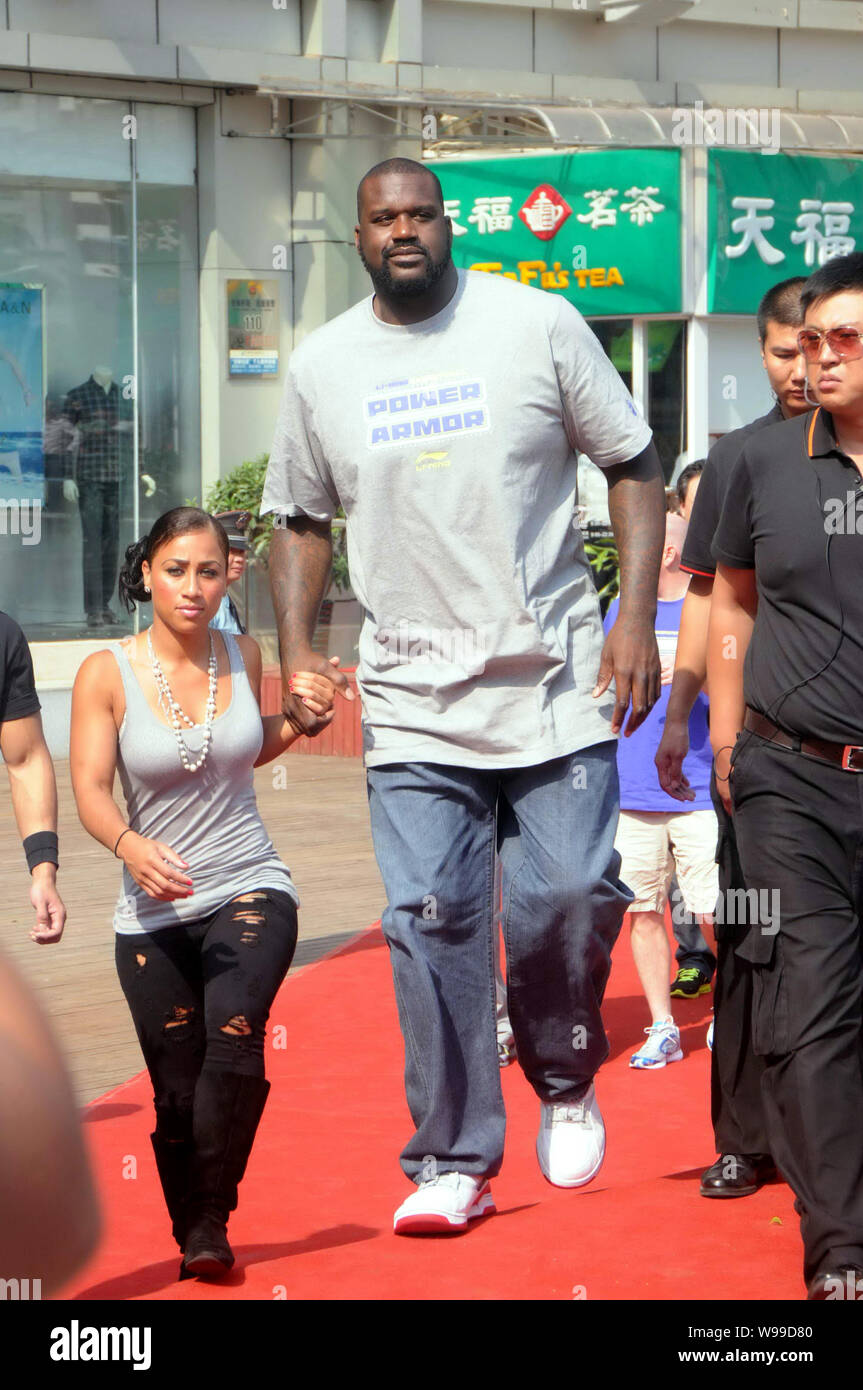 Former NBA superstar Shaquille ONeal and his girlfriend Nicole Hoopz Alexander attend a promotional event by Chinese sportswear brand Li-Ning during h Stock Photo