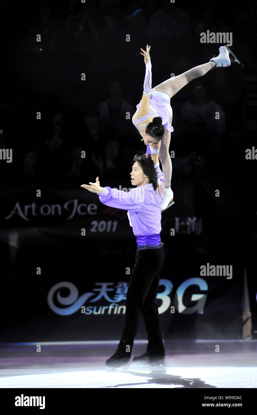 Chinese ice skating duo Pang Qing, top, and Tong Jian perform during an