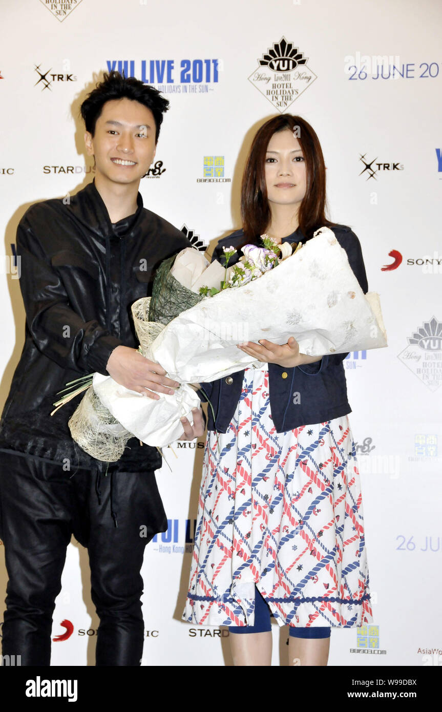 Japanese singer YUI, right, is presented flowers at a press conference for her concert in Hong Kong, China, 15 May 2011.   YUI will hold a concert in Stock Photo