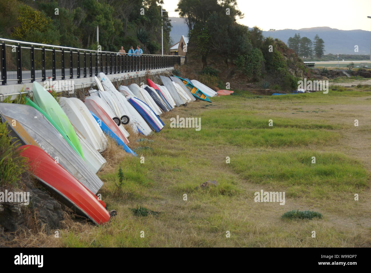 Small dinghies in a row on Brighton Lawn Wollongong Stock Photo