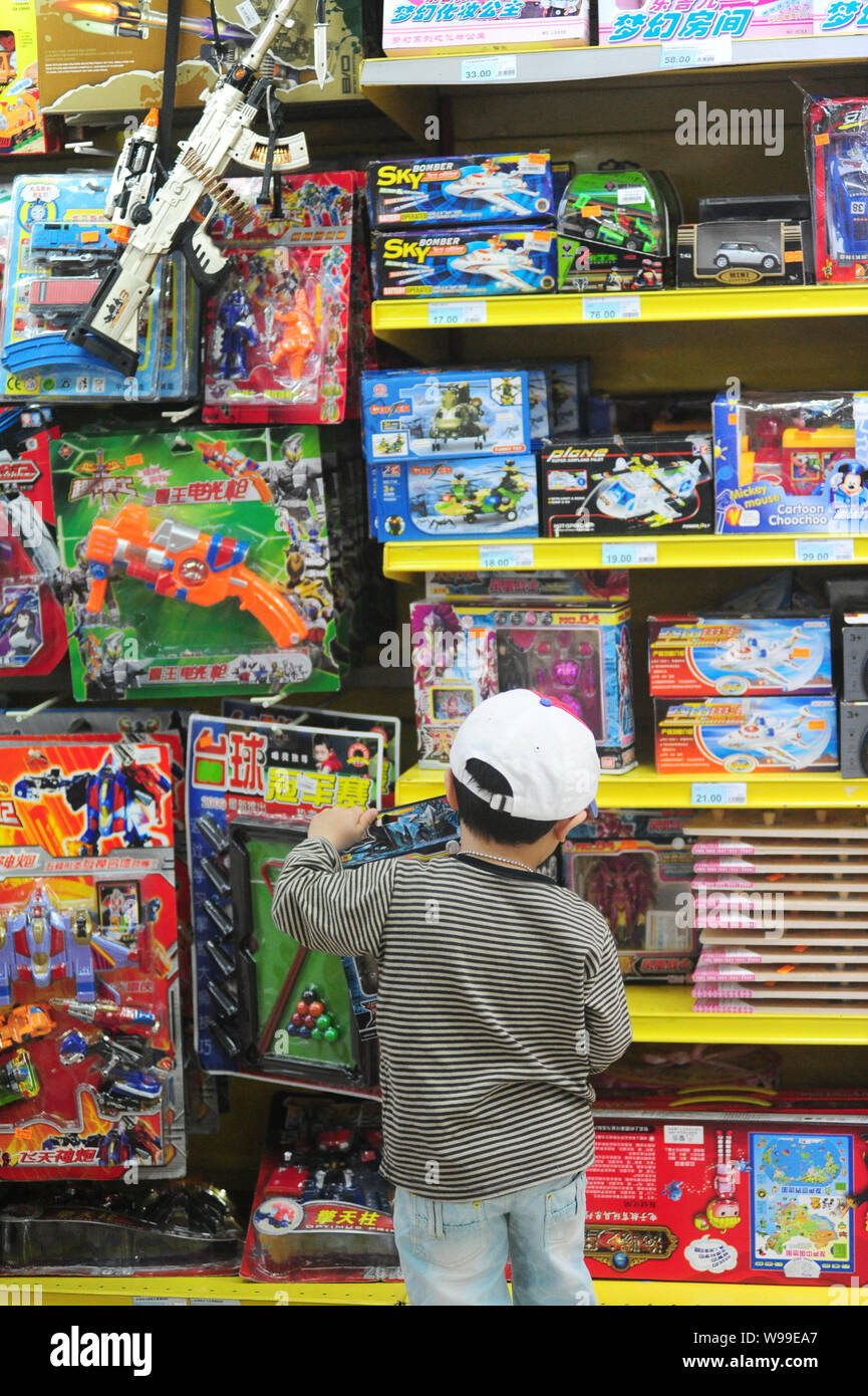 --FILE--A Chinese boy selects toys at a toy store in Qionghai, south Chinas Hunan province, 15 April 2011.  Hundreds of toymakers at the China Import Stock Photo