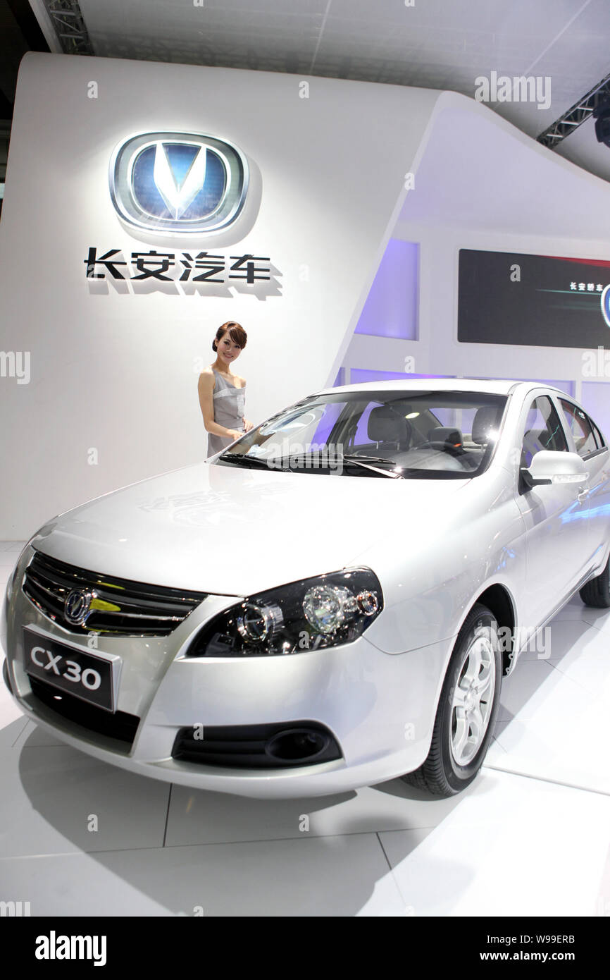 --File-- A model poses with a Changan CX30 during the 8th China (Guangzhou) International Automobile Exhibition, known as Auto Guangzhou 2010, in Guan Stock Photo