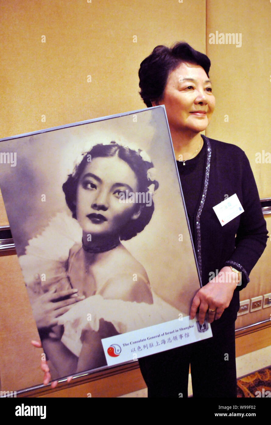 Rosa Hung or Hong Luoxia, 74, shows an old photo of her taken by Jewish
