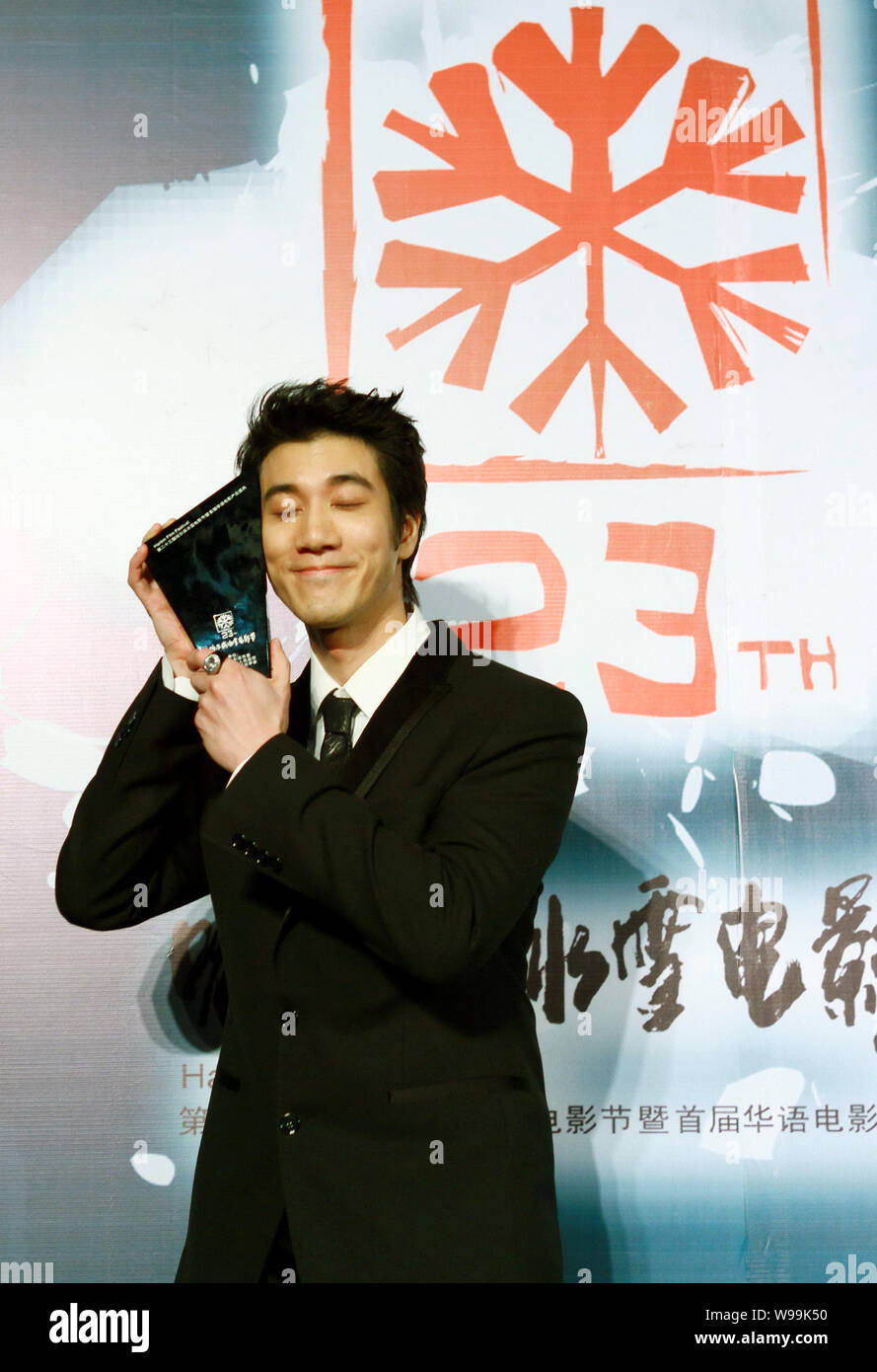 American singer-songwriter Leehom Wang poses with his trophy after the ...