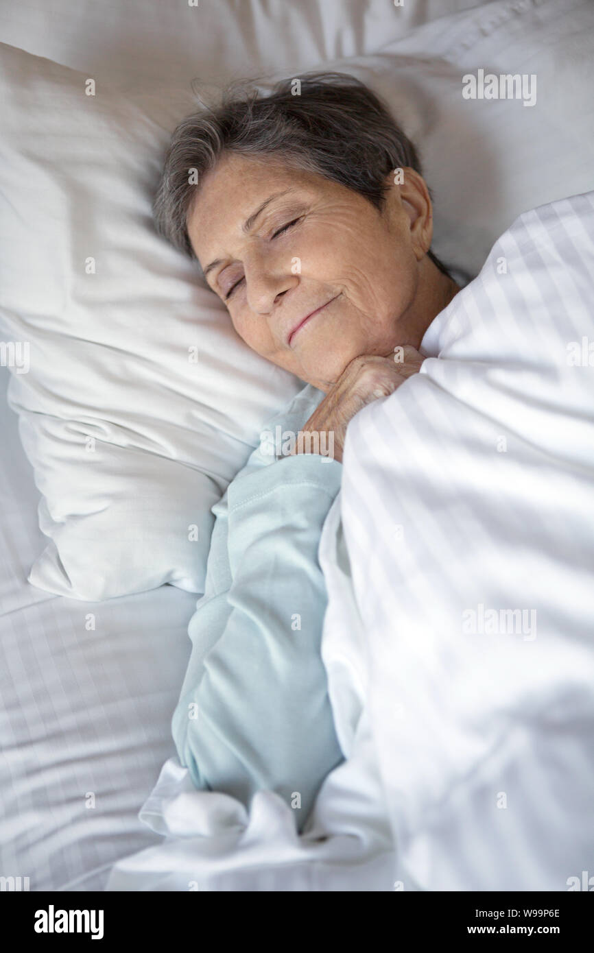 Elderly woman getting a good nights rest. Stock Photo