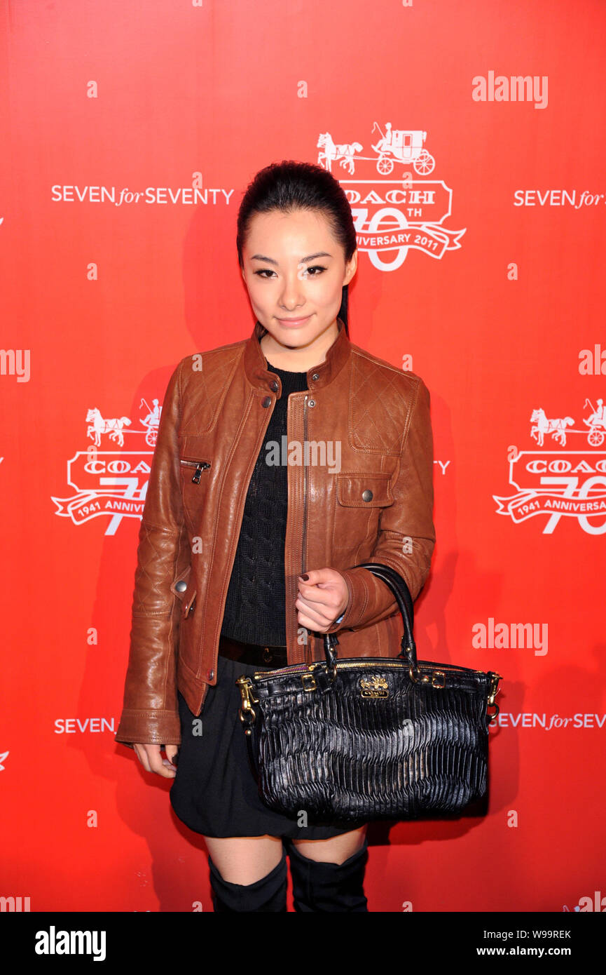 Former Chinese Olympic gymnastics champion Liu Xuan arrives for a banquet celebrating the 70th anniversary of U.S. fashion house COACH in Beijing, Chi Stock Photo