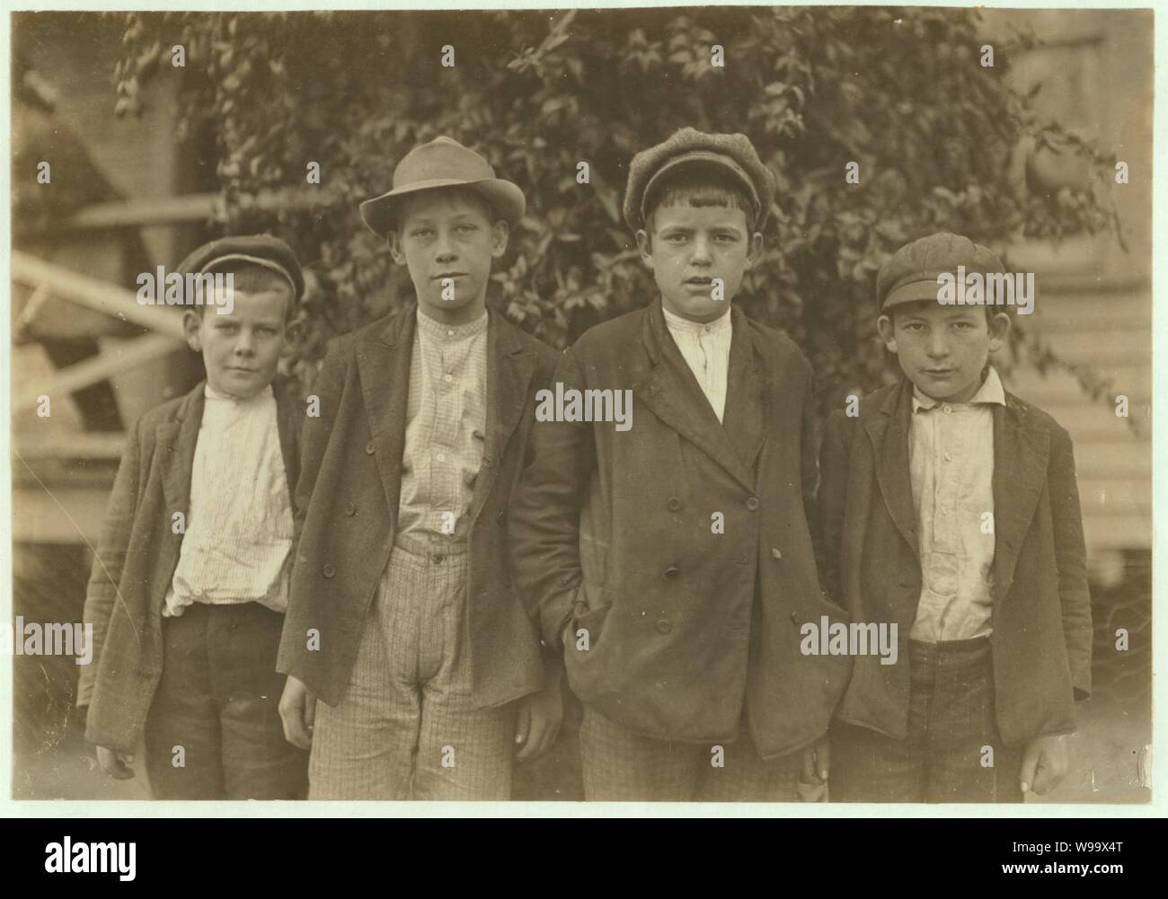 Dickson Mill, Laurinburg, N.C. Robert Black, (smallest) 1 year in mill. John Black, (next) 2 years in mill. Charlie Clark-4 years. Earl Lander-Beginning. Witness, S.R. Hine. Stock Photo