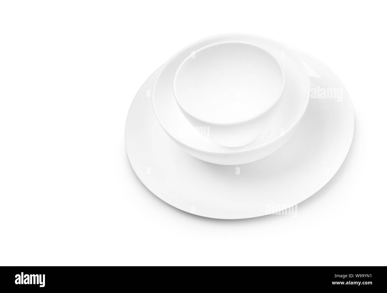 Set of white dishes on table on light background. With clippig path