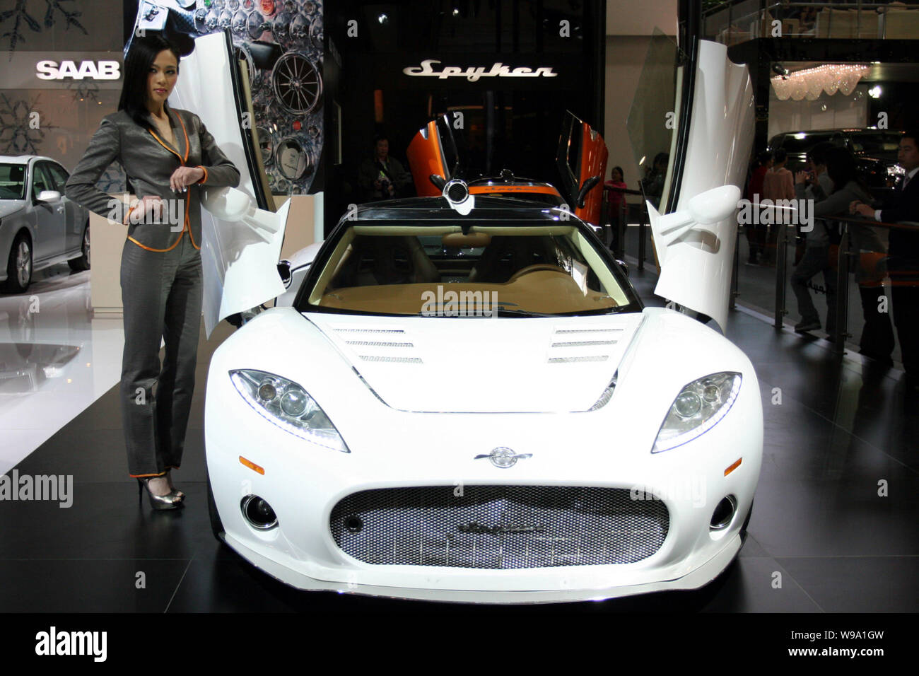 A model poses with a Spyker C8 Aileron during an auto show in Beijing, China, April 23, 2010.   Shares in Spyker Cars, the loss-making Dutch sports ca Stock Photo