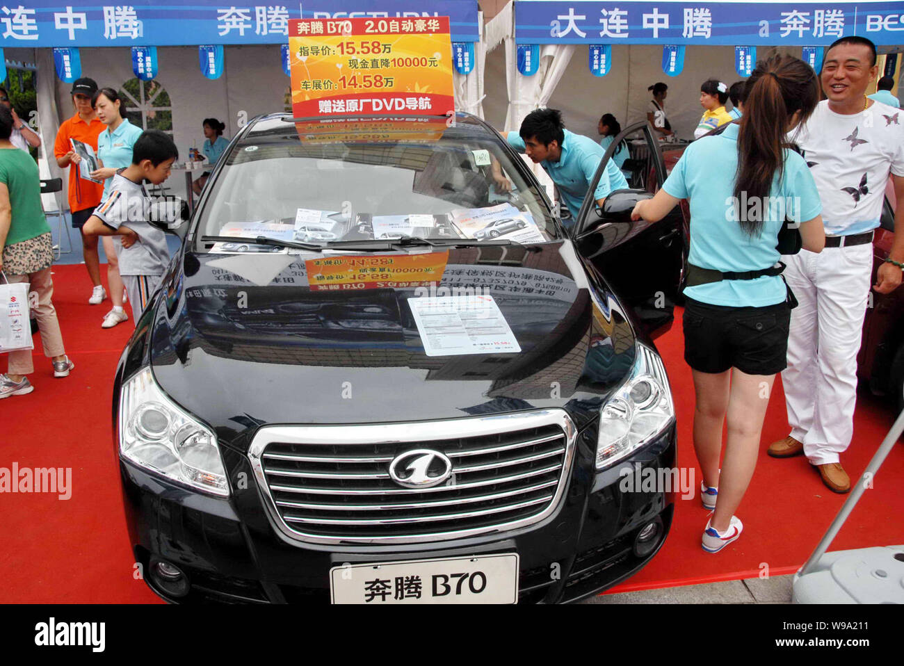 --FILE--Visitors look at an FAW Besturn B70 during an auto show in Dalian city, northeast Chinas Liaoning province, 19 August 2010.   FAW Group, the p Stock Photo