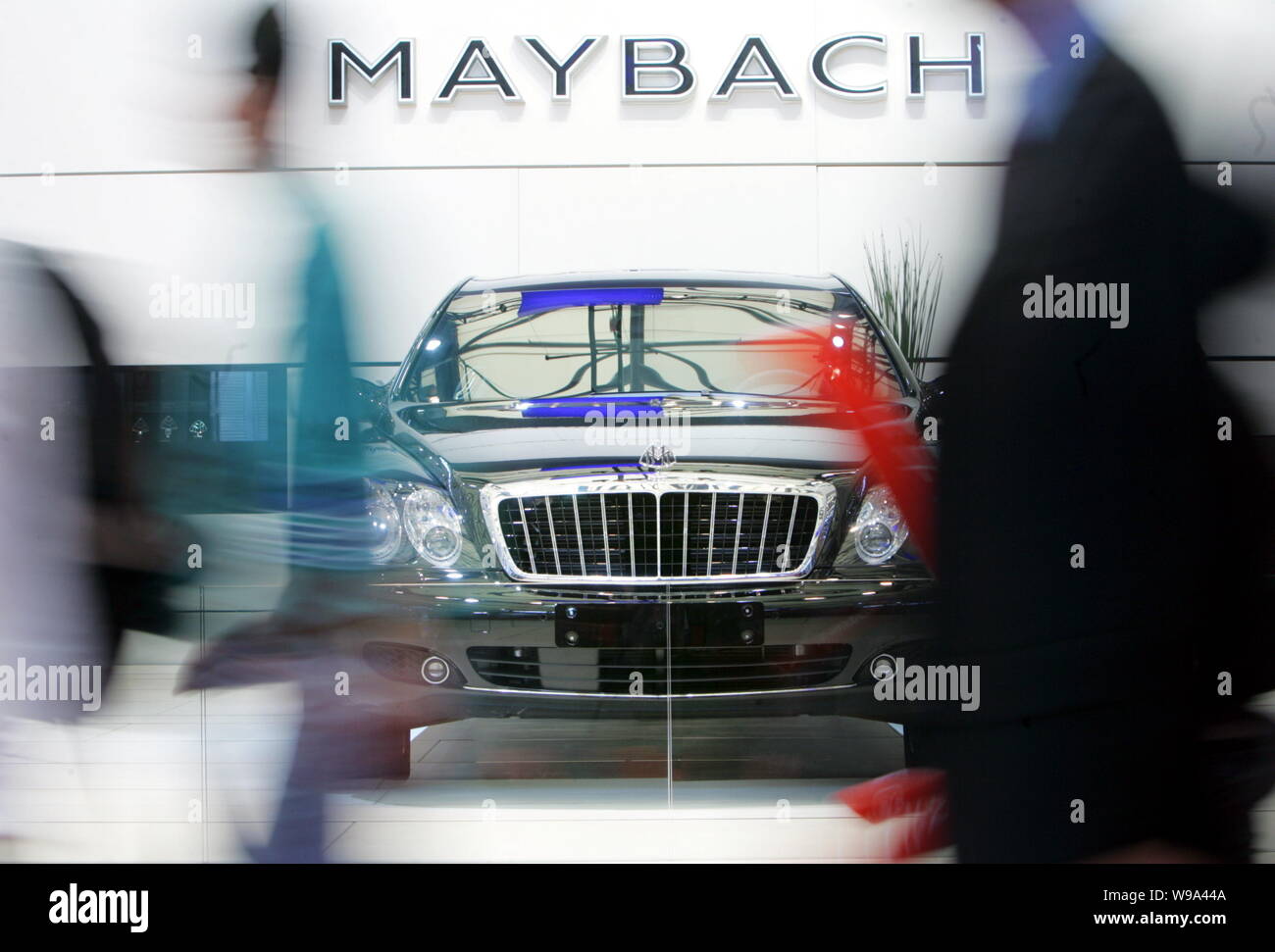 --FILE--Visitors walk past a Maybach limousine at the 12th Shanghai International Automobile Industry Exhibition, known as Auto Shanghai 2007, in Shan Stock Photo