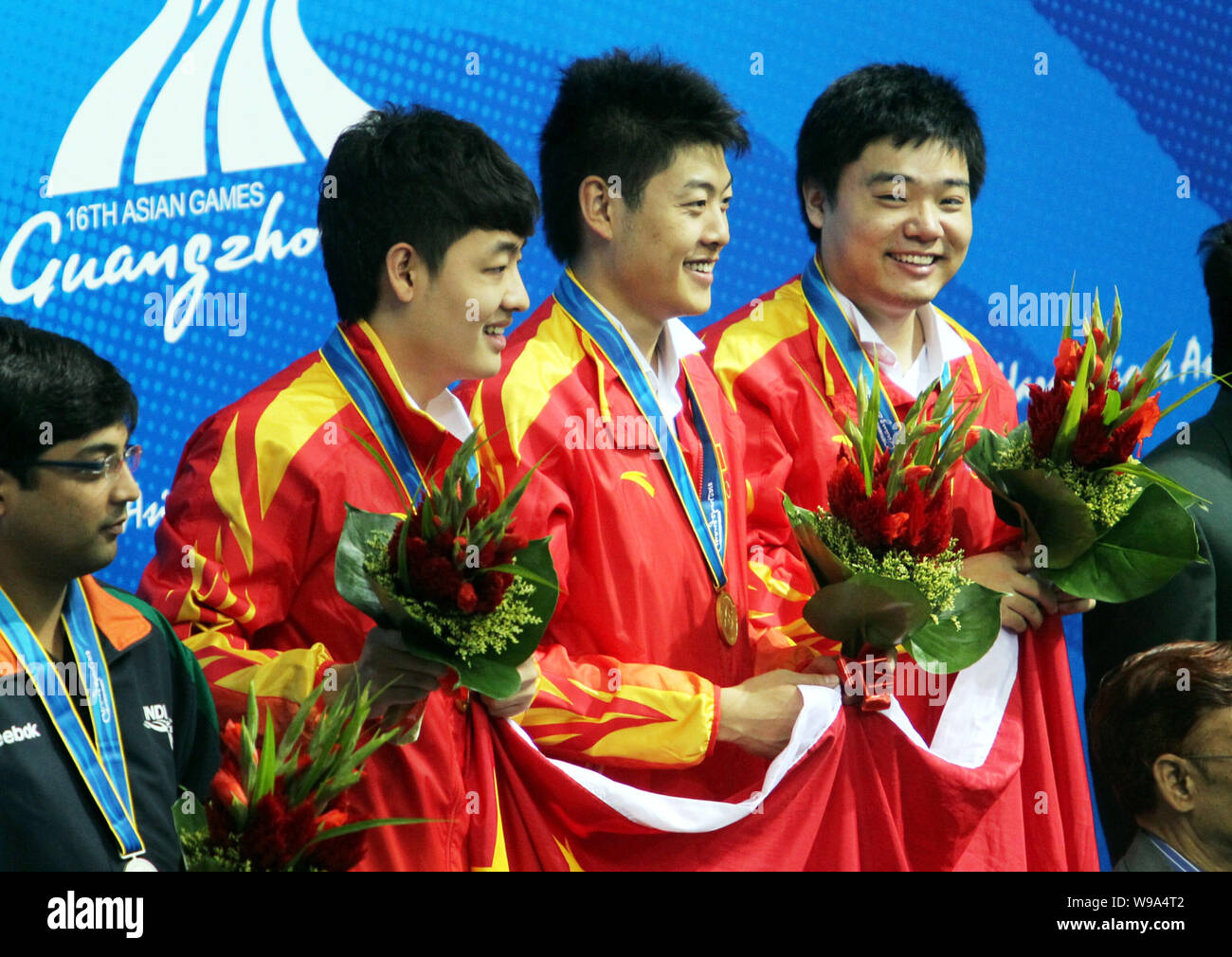 (From second left to second right) Chinas Tian Pengfei, Liang Wenbo and Ding Junhui (gold medalists) stand on the podium during the award ceremony for Stock Photo
