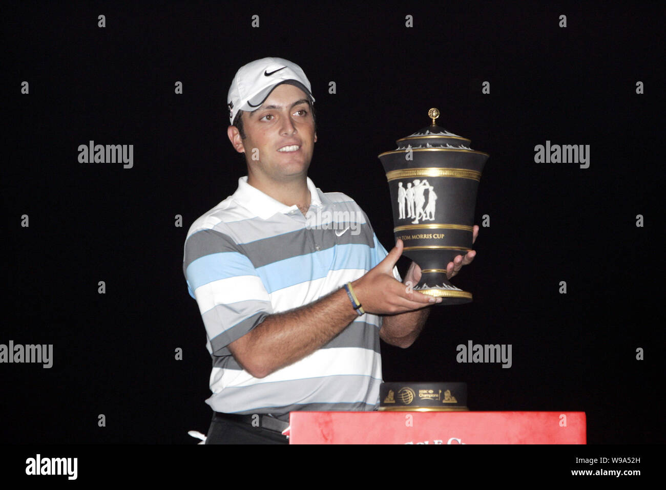Italian golfer Francesco Molinari holds his trophy during the award