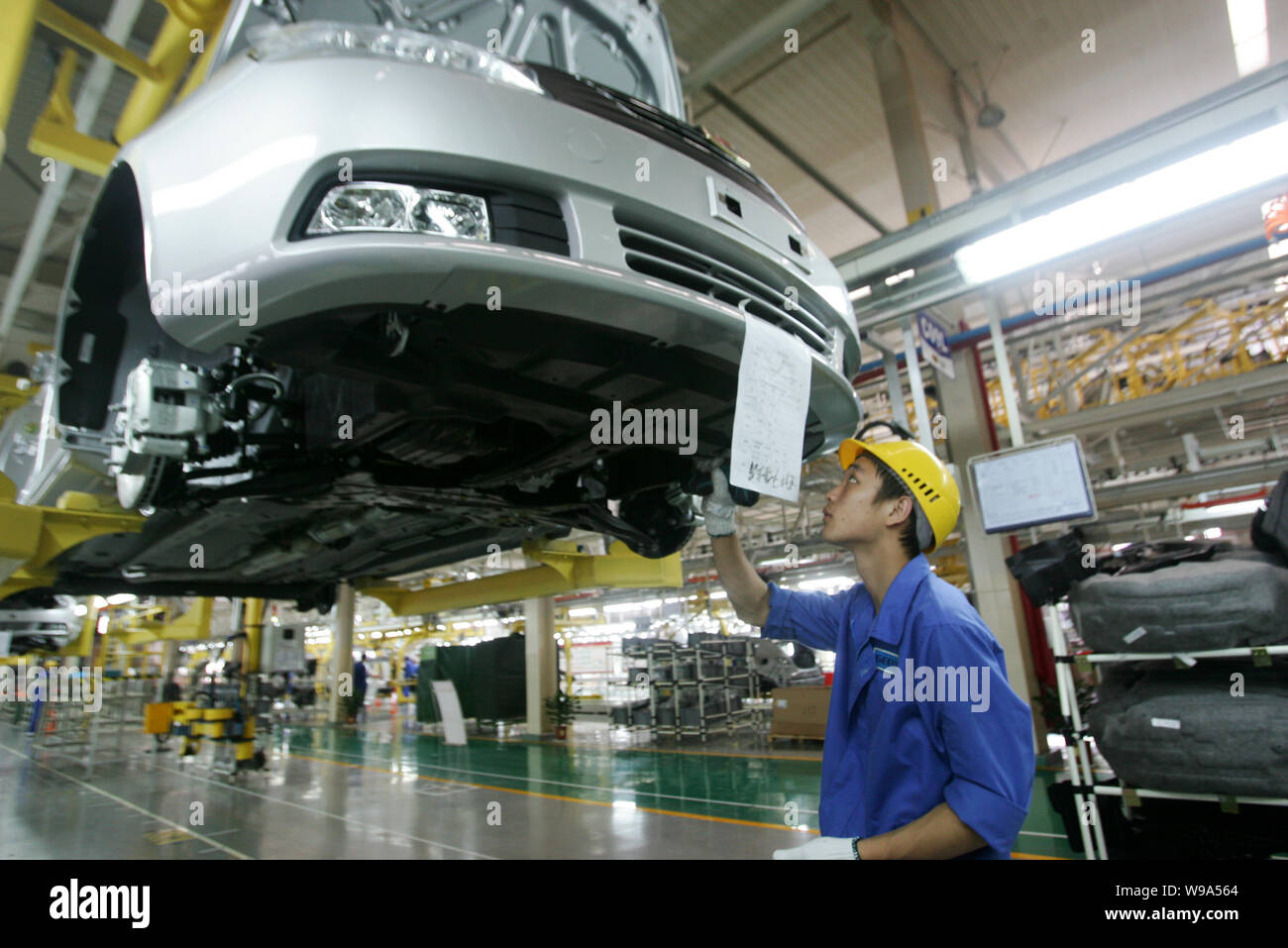 FILEA Chinese factory worker assembles an Emgrand car on the