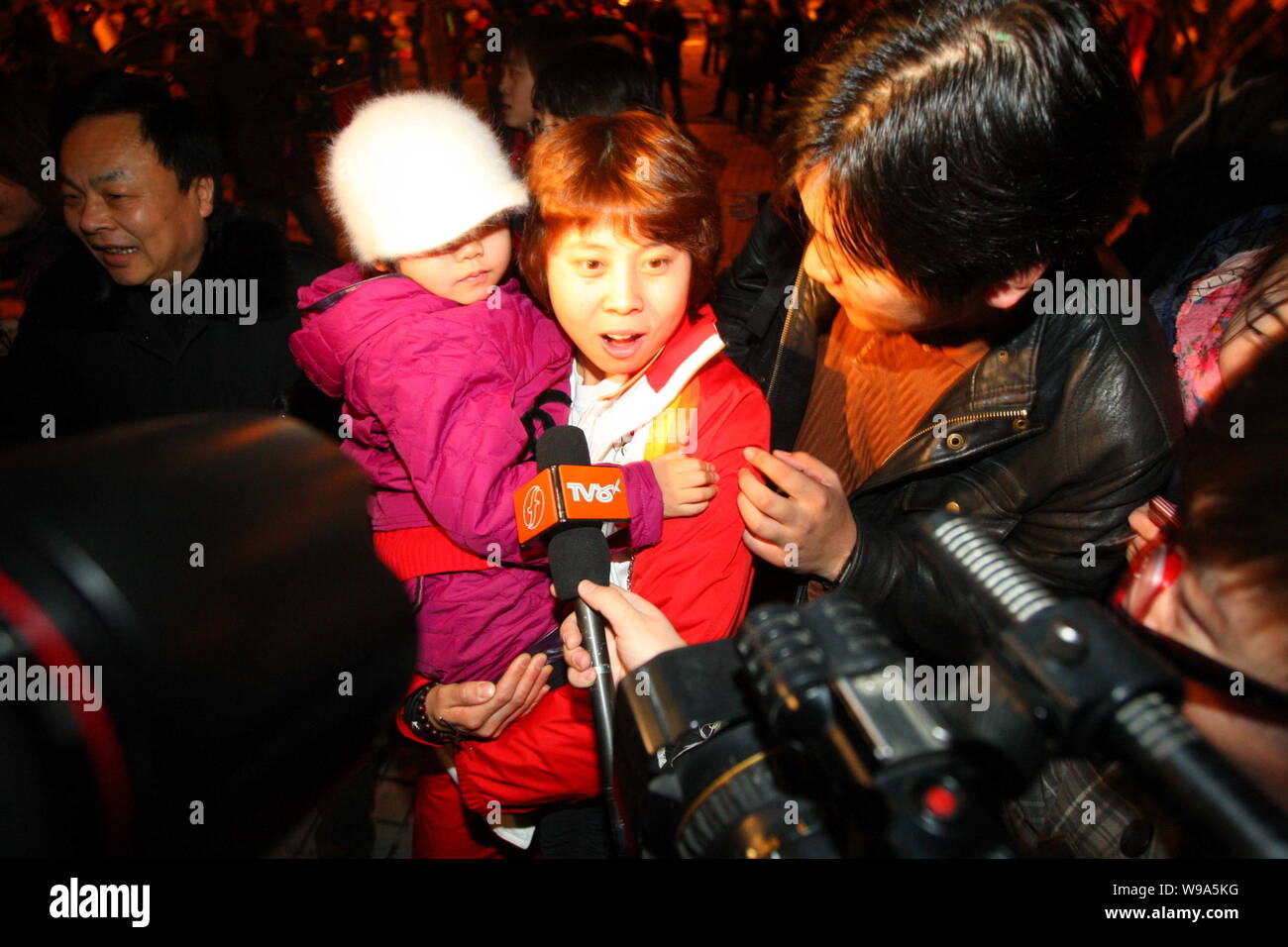 Wang Meng, center, three gold medals holder at the Vancouver Winter Games, is interviewed after arriving in Beijing, China, Tuesday, 2 March 2010.   T Stock Photo
