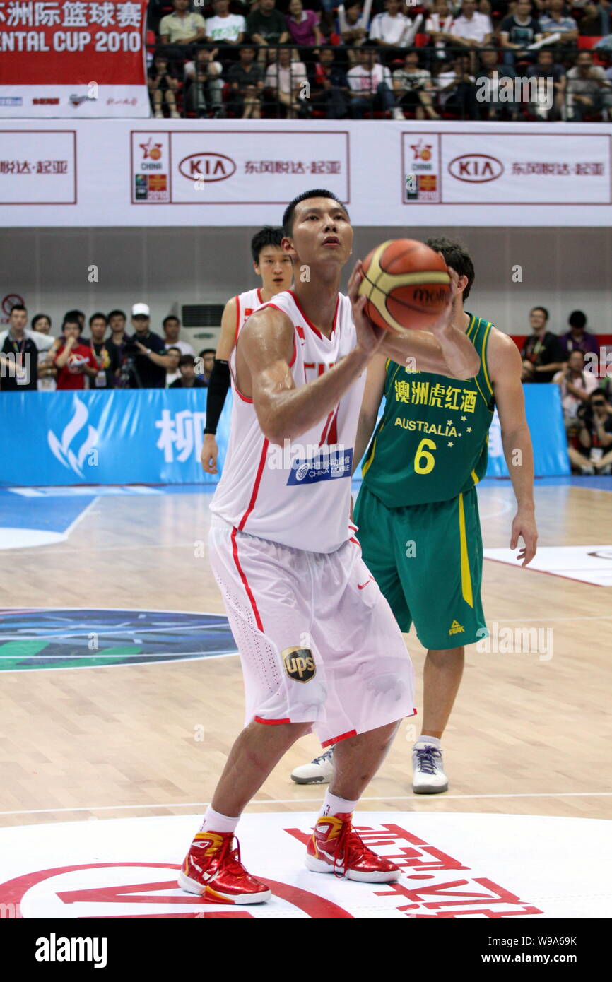 Chinese basketball player Yi Jianlian of the Washington Wizards (front) shoots in a basketball match between China and Australia Boomers during the FI Stock Photo