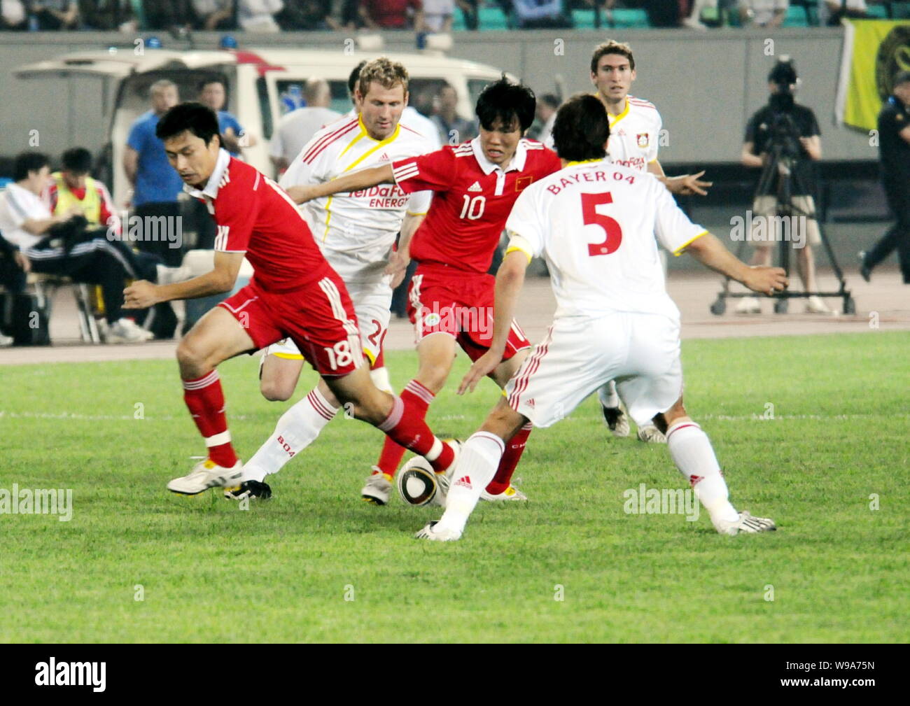 Gao Lin, left, and Deng Zhuoxiang, center, of the Chinese national mens soccer team vie with Manuel Friedrich, front, and Lukas Sinkiewicz, second lef Stock Photo