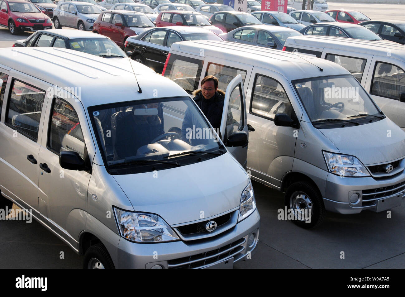 Chinese car buyers try out a minivans at an auto dealership in Tancheng  county, Linyi city, east Chinas Shandong province, 29 December 2010. China  w Stock Photo - Alamy