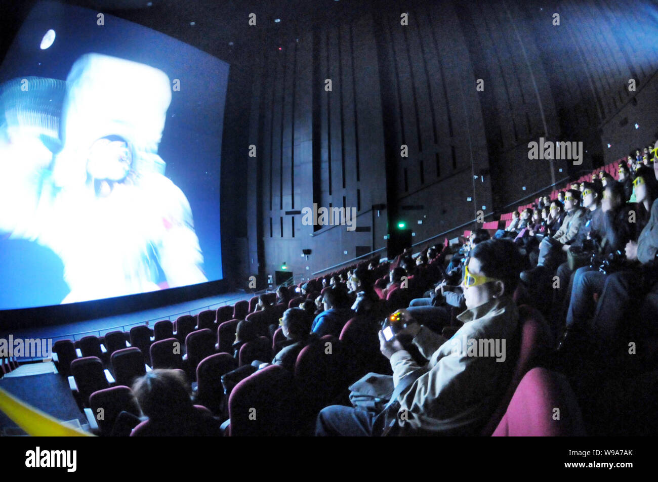 Tourists watch a 3D movie in the cinema at the Fantawild Dreamland theme  park in Wuhu city, east Chinas Anhui province, 8 December 2010. Fantawild D  Stock Photo - Alamy