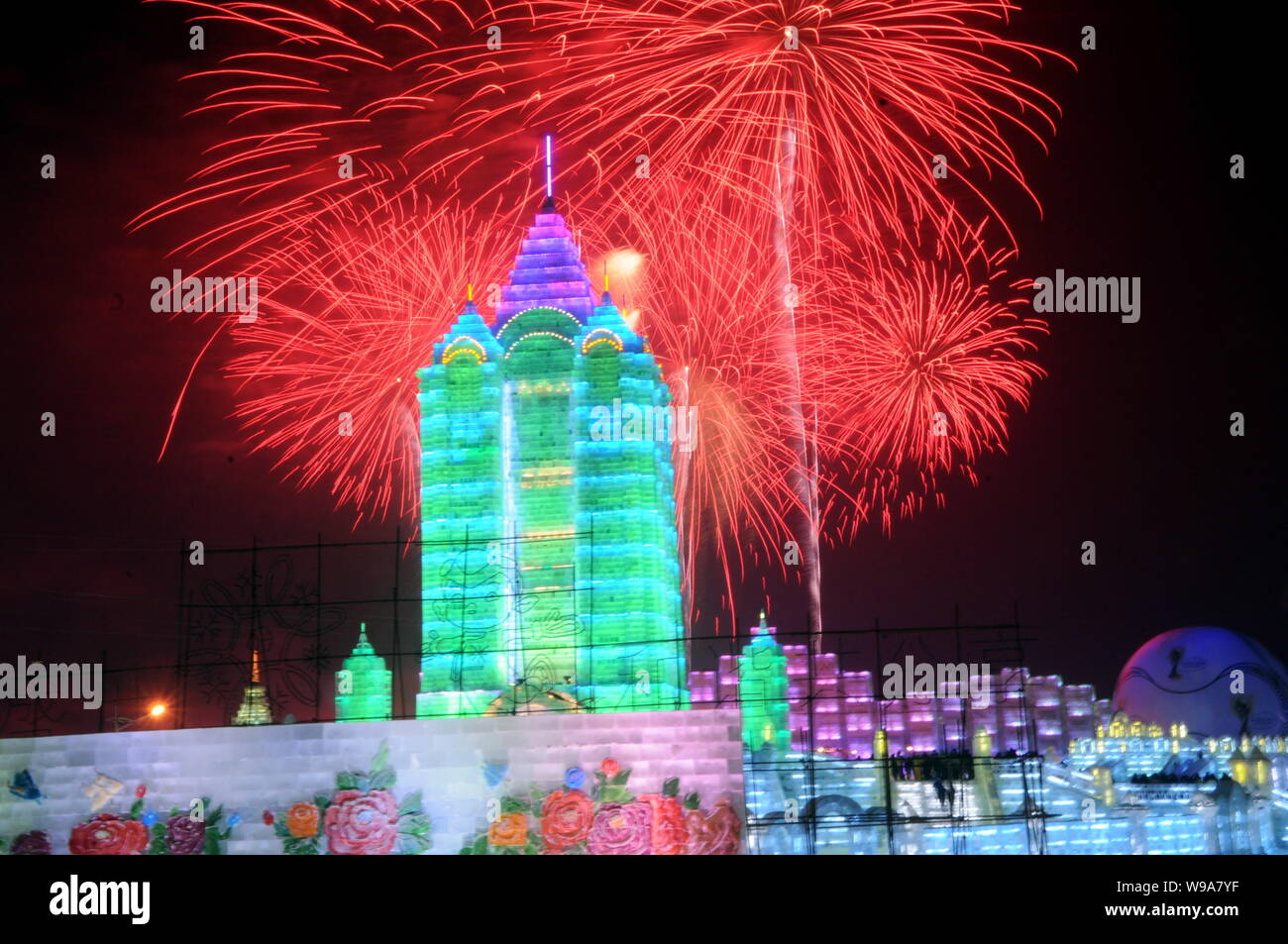 Fireworks explode over ice sculptures during the opening ceremony of