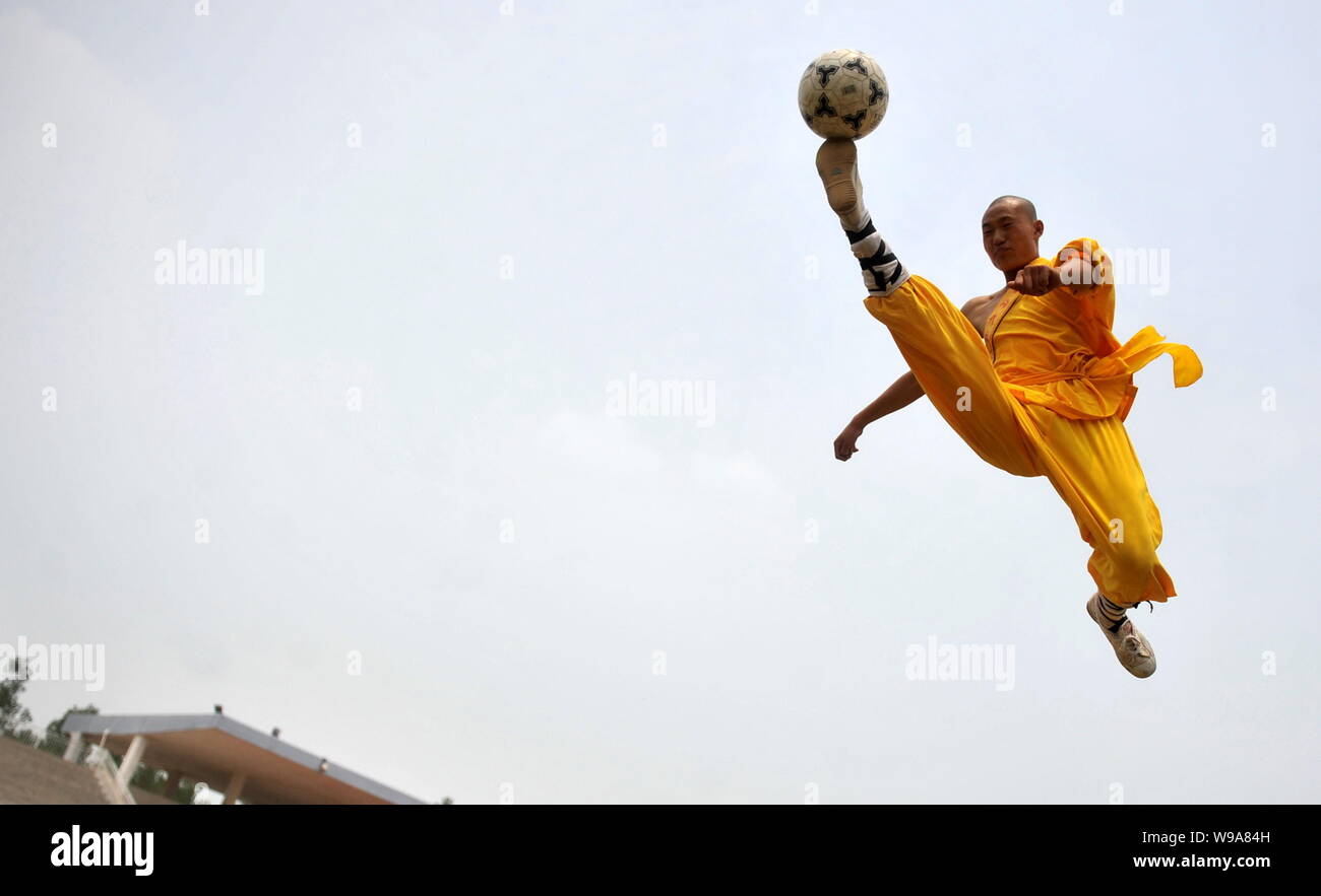 A young Chinese monk from Shaolin Temple Tagou Wushu School practise Kungfu football skills during a training session in Zhengzhou, central Chinas Hen Stock Photo