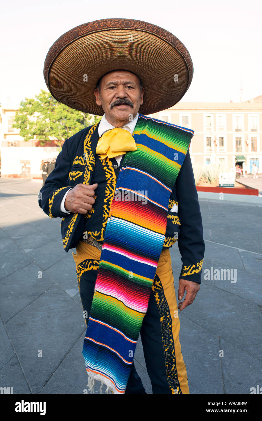 Mariachi (among many competitor mariachis) waiting to be hired for an impromptu in-the-plaza serenade. Garibaldi Square, Mexico City, Mexico. Jun 2019 Stock Photo