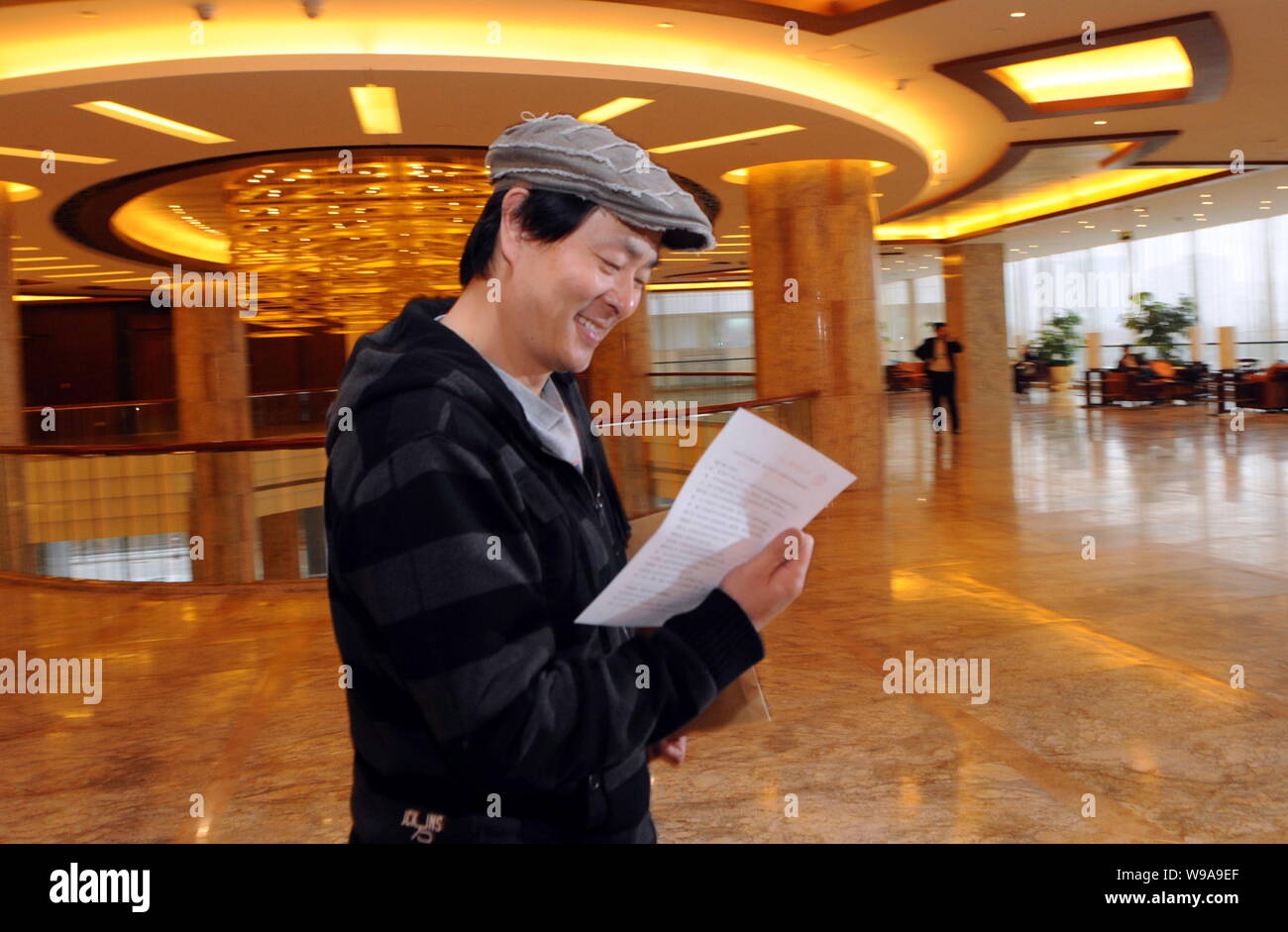 Chinese actor Pu Cunxin, also a delegate of CPPCC (Chinese Peoples Political Consultative Conference), the countrys top political advisory body, reads Stock Photo