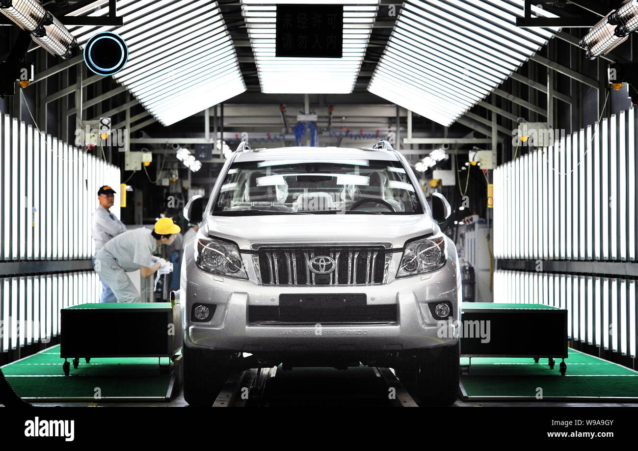 Chinese workers assemble a Toyota Prado at a new factory of Sichuan FAW