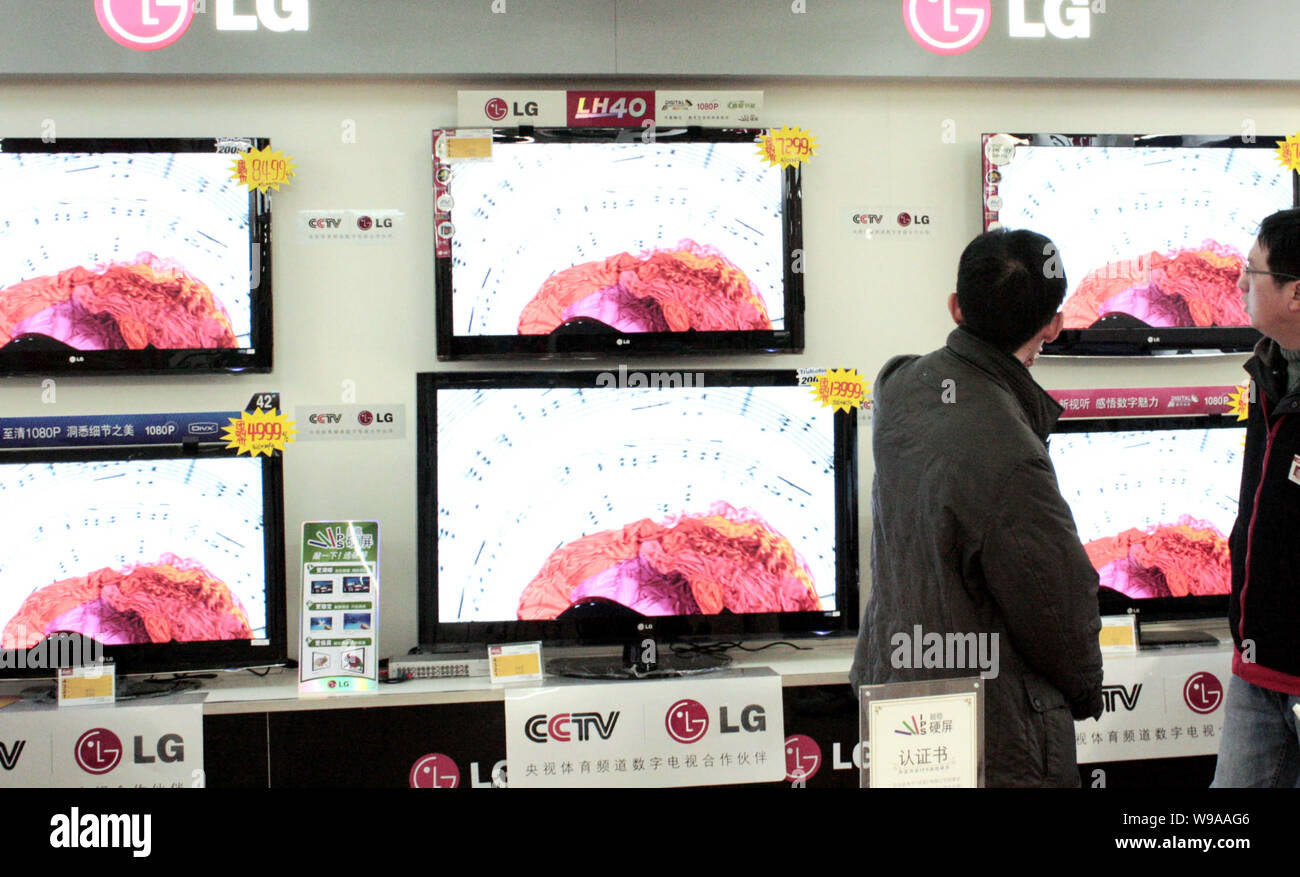 --FILE--Chinese customers shop for LG LCD televisions at a home appliances store in Yichang city, central Chinas Hubei province, 12 March 2010.   Sams Stock Photo