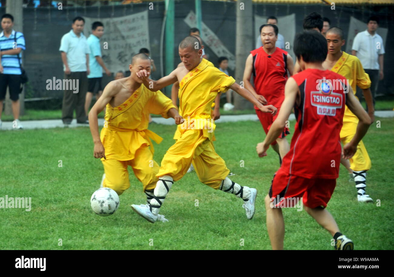 Young Chinese monks from Shaolin Temple Tagou Wushu School compete with Chinese soccer fans during a football match in Zhengzhou, central Chinas Henan Stock Photo