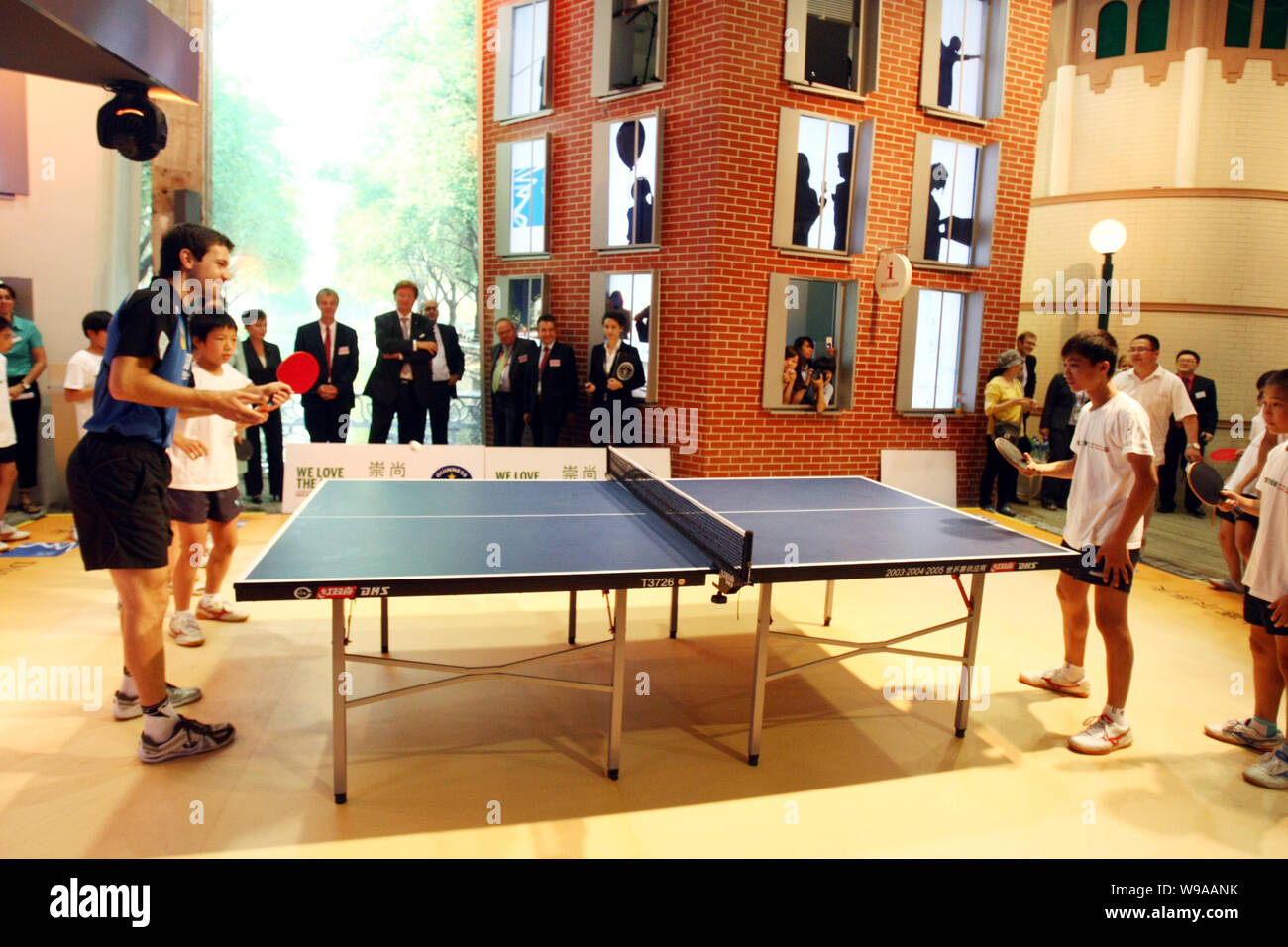 German table tennis player Timo Boll, left, and Chinese students take