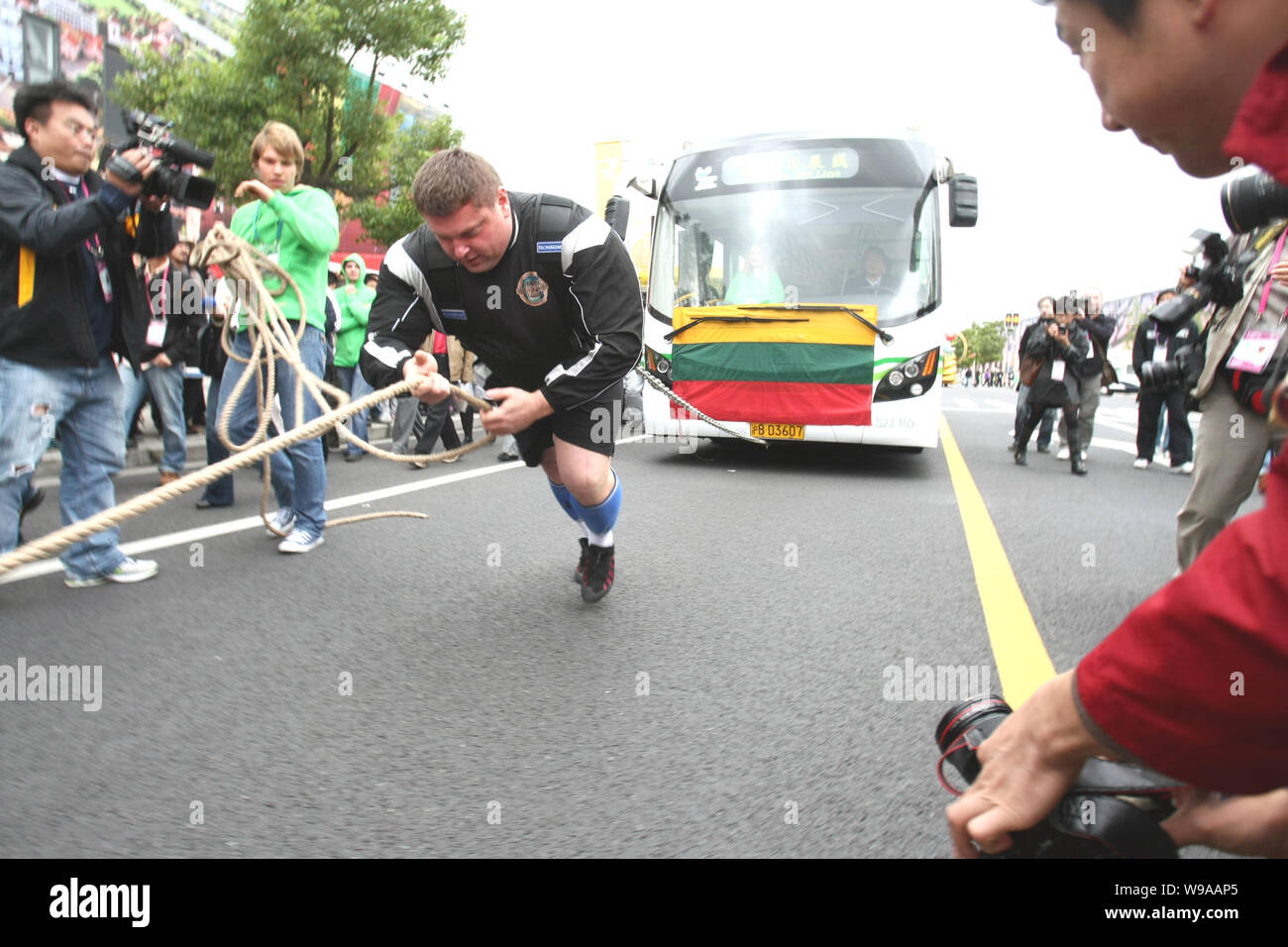 The Worlds Strongest Man title holder Zydrunas Savickas pulls a bus to ...