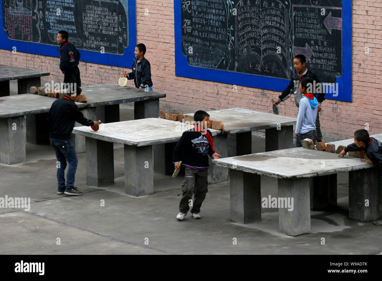 Hui ethnic students play table tennis at the Heping Primary School in Linxia, northwest Chinas Gansu province, June 30, 2010.   Heping Primary School Stock Photo