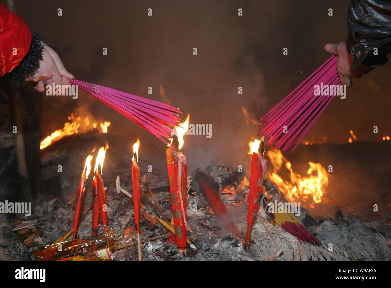 Chinese people burn offerings to worship the God of Wealth in Chinese ...