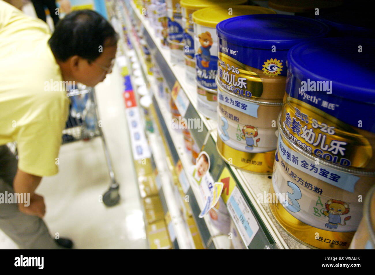 --FILE--A Chinese customer shops for Wyeth milk powder at a supermarket in Shanghai, China, 21 September 2009.   Chinese Mainland dairy producers have Stock Photo