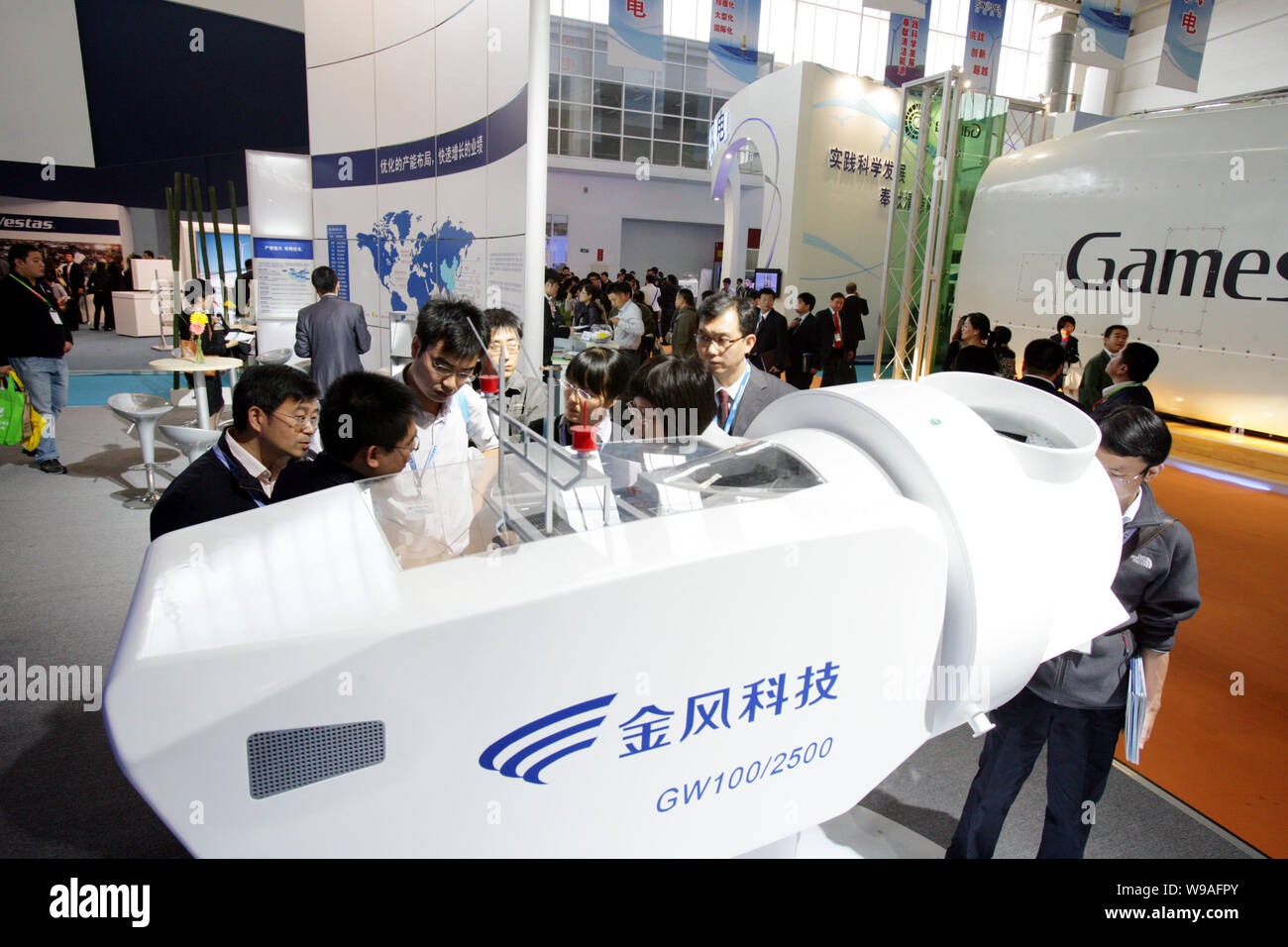 FILEChinese visitors look at a model wind turbine on the booth of