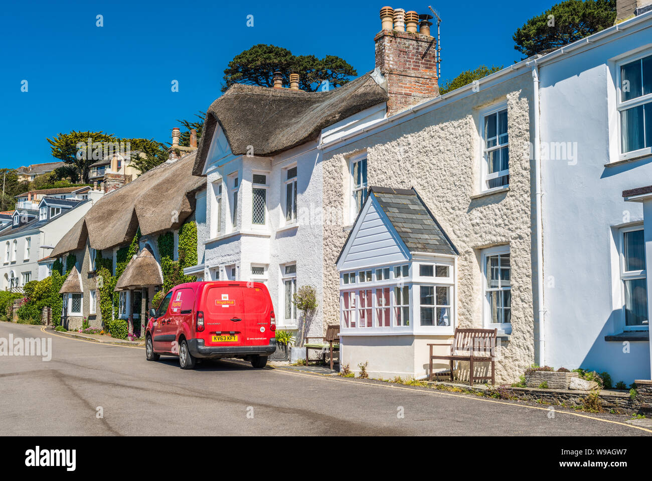 A Royal Mail van delivering post at the picturesque village of St Mawes on the Roseland Peninsula near Falmouth in Cornwall, England, UK. Stock Photo