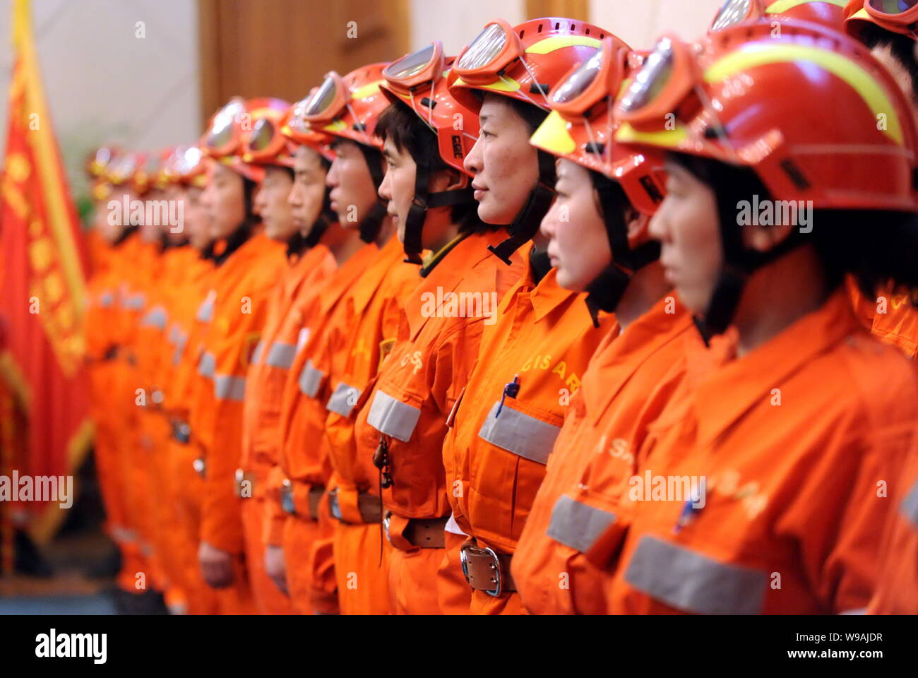 Chinese rescuers stand during a departure ceremony before leaving for ...