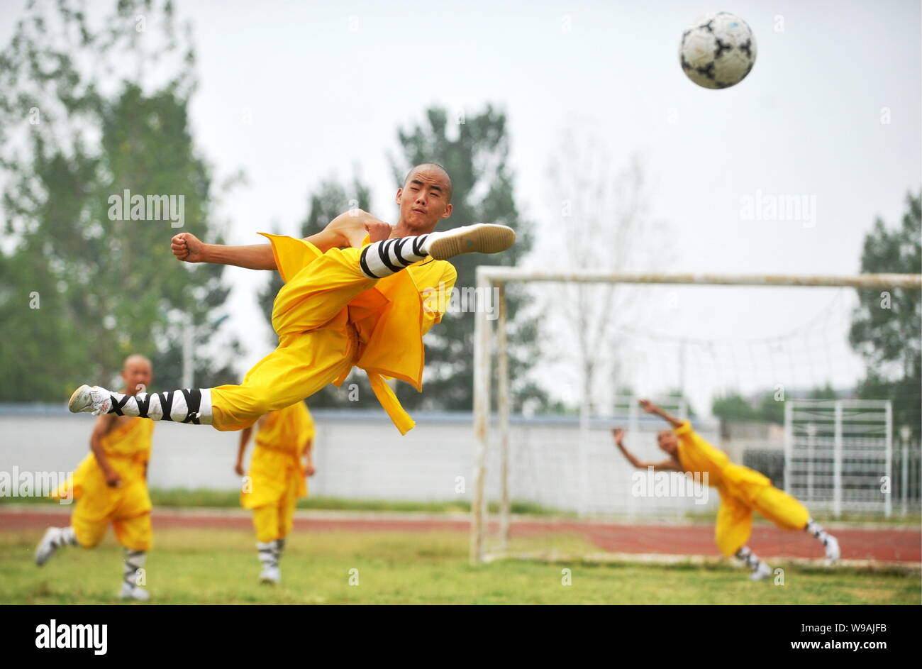 Young Chinese monks from Shaolin Temple Tagou Wushu School practise Kungfu football skills during a training session in Zhengzhou, central Chinas Hena Stock Photo