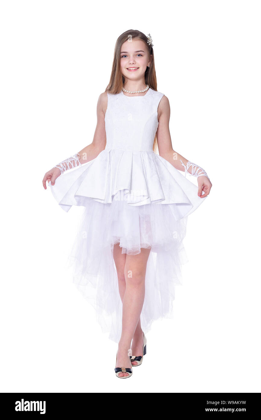 Happy beautiful little girl in white dress posing isolated Stock Photo ...