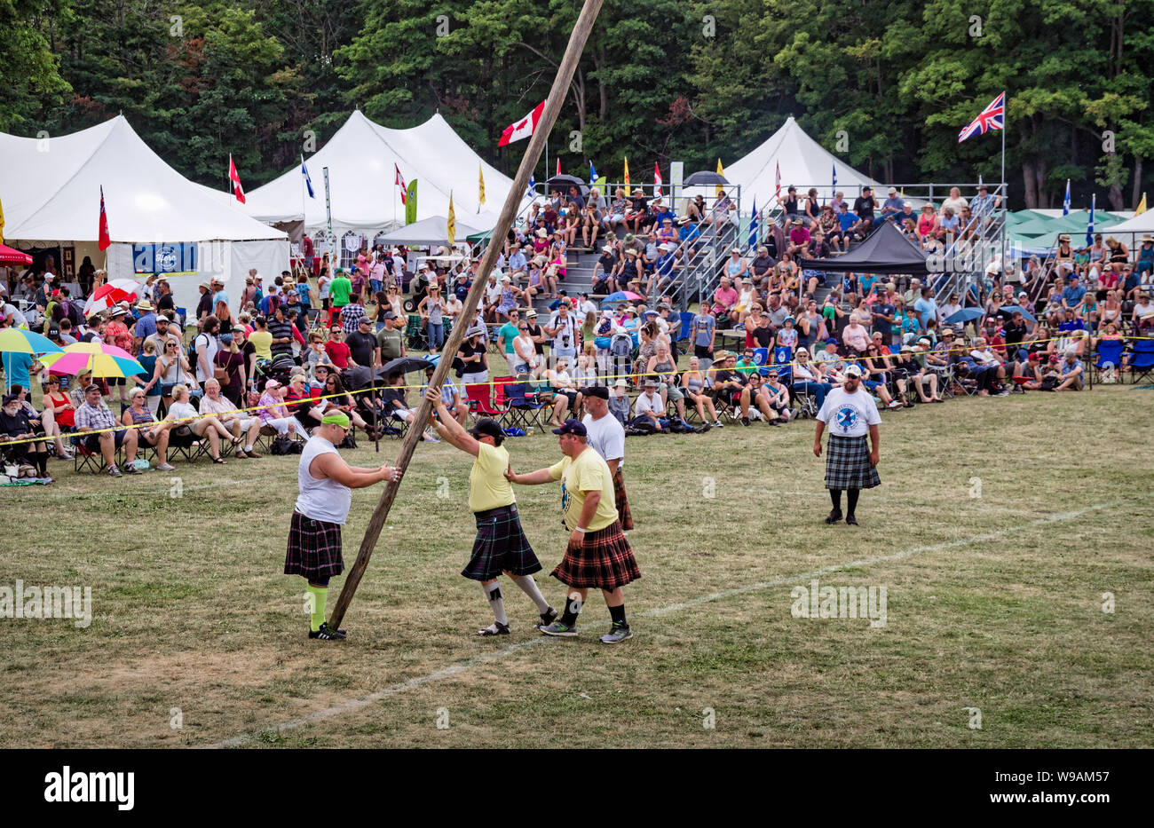 Fergus, Ontario, Canada - 08 11 2018: Traditional Scottish heavies competitions athletes wearing kilts are preparing to demonstrate their skills in a Stock Photo