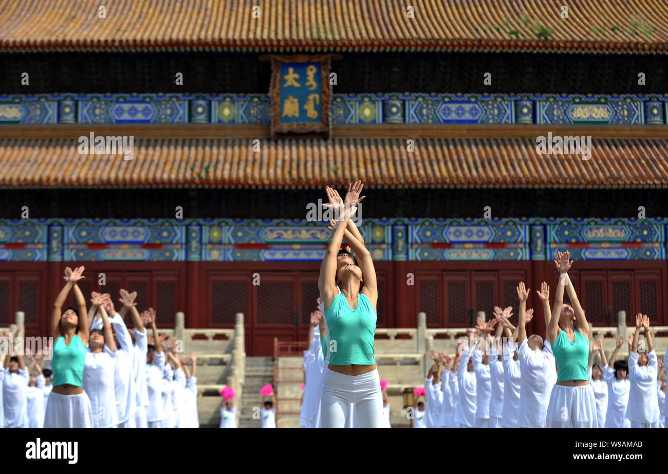 Chinese participants do a synchronized physical exercise during a ...