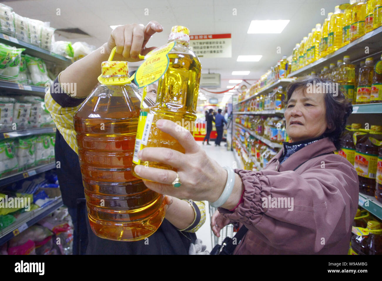 Chinese customers shop for cooking oil at a supermarket in Shanghai, China, 14 December 2010.   Cooking oil, an otherwise innocuous kitchen item, lies Stock Photo