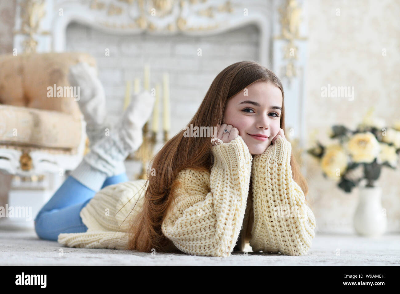 Portrait of beautiful teen girl lying on floor in room Stock Photo - Alamy