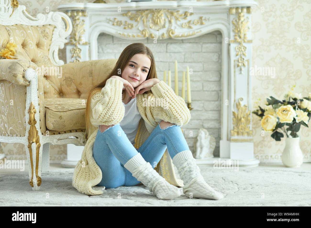 Portrait of beautiful teen girl sitting on floor Stock Photo - Alamy