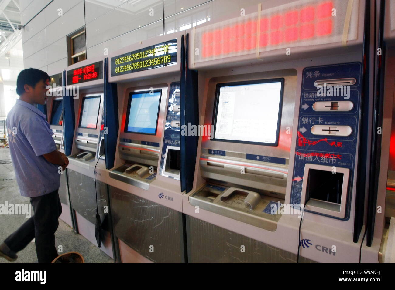 A Chinese worker tests train ticket vending machines in the Shanghai Hongqiao Railway Station in Shanghai, China, 28 June 2010.   Traffic officials ar Stock Photo