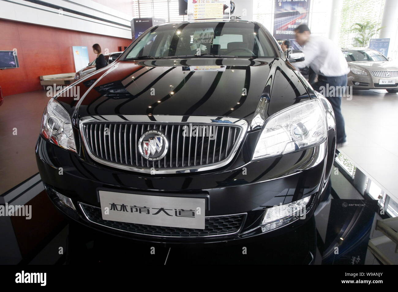 --FILE--A Chinese buyer looks at a Buick Park Avenue of Shanghai GM