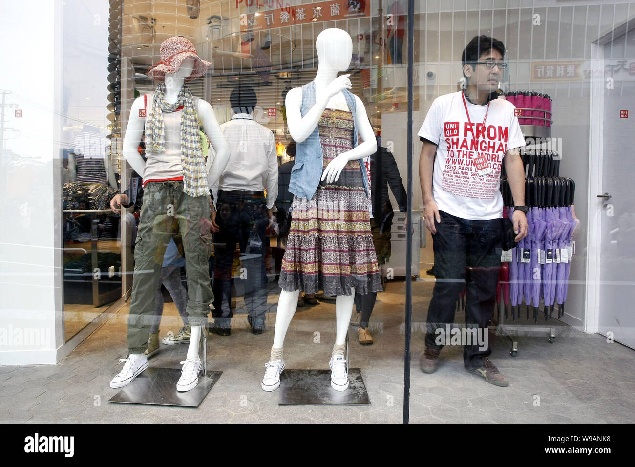 FILE--A staff works in the Uniqlo flagship store in Shanghai, China, 15 May  2010. Looking to become the worlds leading clothing retailer, Japans F  Stock Photo - Alamy