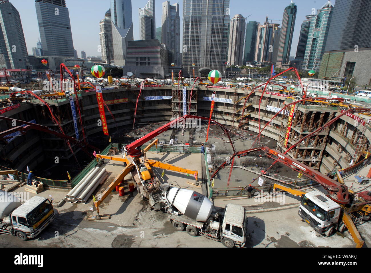 Chinese construction workers concrete the foundation of the Shanghai